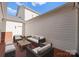 Private brick patio with comfortable outdoor seating, perfect for relaxation and entertaining at 155 Harper Lee St, Davidson, NC 28036