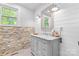 Stylish bathroom with shiplap walls, a stone accent wall, and a modern vanity with a marble countertop at 1574 Jarrett Farm Rd, Newton, NC 28658