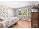 Cozy bedroom features hardwood floors, closet, and window with backyard view at 1574 Jarrett Farm Rd, Newton, NC 28658