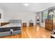 Bright bedroom boasts hardwood floors, two windows, a plush bed, and an ornate decorative mirror and fan at 1574 Jarrett Farm Rd, Newton, NC 28658