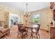 Elegant dining room with hardwood floors, patterned wallpaper, and vintage furnishings at 1574 Jarrett Farm Rd, Newton, NC 28658