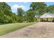Long driveway leading to a carport and a view of the house surrounded by lush greenery at 1574 Jarrett Farm Rd, Newton, NC 28658