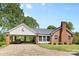 Charming brick home featuring an attached covered carport and manicured landscaping at 1574 Jarrett Farm Rd, Newton, NC 28658