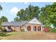 Sprawling single-story brick home showcasing elegant columns and a covered front porch at 1574 Jarrett Farm Rd, Newton, NC 28658
