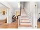 Inviting foyer with hardwood floors, staircase, and views into adjacent rooms at 1574 Jarrett Farm Rd, Newton, NC 28658