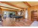 Spacious game room features wood paneling, pool table, exercise equipment, and natural light through sliding glass doors at 1574 Jarrett Farm Rd, Newton, NC 28658