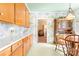 Quaint kitchen with wood cabinetry, decorative wallpaper, and ample lighting at 1574 Jarrett Farm Rd, Newton, NC 28658