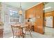 Eat-in kitchen with wood cabinets and a view to outside window at 1574 Jarrett Farm Rd, Newton, NC 28658