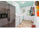 Laundry room features modern appliances, storage cabinets, a window, and quirky plaid patterned wallpaper on the ceiling at 1574 Jarrett Farm Rd, Newton, NC 28658