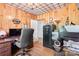 Functional home office with wood paneling, a patterned ceiling, built in safe, and ample workspace at 1574 Jarrett Farm Rd, Newton, NC 28658