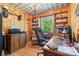 Home office features wood paneling, built-in bookshelves, a large desk, and a bright window with natural light at 1574 Jarrett Farm Rd, Newton, NC 28658