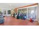 Sunroom with red tile, lots of natural light and an array of belongings at 1574 Jarrett Farm Rd, Newton, NC 28658