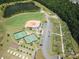 Aerial view of community amenities including a baseball field, garden, pond, and tennis courts at 16291 Raven Crest Dr, Indian Land, SC 29707