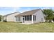 Backyard featuring a screened-in porch and landscaped lawn with a view of other homes at 16291 Raven Crest Dr, Indian Land, SC 29707