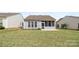 Backyard of home with a screened-in porch and lush green lawn at 16291 Raven Crest Dr, Indian Land, SC 29707
