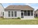 Exterior view of the screened-in porch and backyard with a well-manicured lawn at 16291 Raven Crest Dr, Indian Land, SC 29707