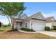 Charming gray home featuring a well-manicured front yard and attached two-car garage at 16291 Raven Crest Dr, Indian Land, SC 29707