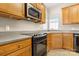 Close-up of an updated kitchen with stainless steel appliances, custom cabinets, and tile floors at 16291 Raven Crest Dr, Indian Land, SC 29707