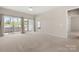 Sun-filled living room features large sliding doors to the screened porch and plush carpeting at 16291 Raven Crest Dr, Indian Land, SC 29707