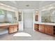 Primary bathroom featuring dual vanities, tile floors, and decorative columns to an adjacent room at 16319 Ashlyn Chase Ct, Charlotte, NC 28277