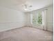 Bedroom with beadboard trim, ceiling fan and large windows letting in natural light at 16319 Ashlyn Chase Ct, Charlotte, NC 28277
