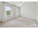 Bright bedroom featuring large windows adorned with white, ruffled curtains, offering ample natural light at 16319 Ashlyn Chase Ct, Charlotte, NC 28277