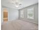 This bedroom has a ceiling fan, carpet, and windows that offer plenty of natural light at 16319 Ashlyn Chase Ct, Charlotte, NC 28277