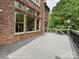 Back deck featuring a brick home exterior and forested view at 16319 Ashlyn Chase Ct, Charlotte, NC 28277