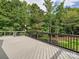 Spacious deck surrounded by lush greenery offering a tranquil outdoor space at 16319 Ashlyn Chase Ct, Charlotte, NC 28277