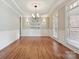 Bright dining room featuring hardwood floors, classic wainscoting, and an elegant chandelier at 16319 Ashlyn Chase Ct, Charlotte, NC 28277