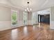 Open-concept dining area with hardwood floors, a chandelier, and an easy transition to living spaces at 16319 Ashlyn Chase Ct, Charlotte, NC 28277