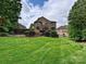 The large backyard features mature landscaping, a custom pool, and well-maintained lawn at 16319 Ashlyn Chase Ct, Charlotte, NC 28277