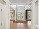 Grand foyer with gleaming hardwood floors, white columns, and a view of the front entrance at 16319 Ashlyn Chase Ct, Charlotte, NC 28277