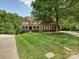 Beautifully landscaped home with lush green lawn, mature trees, and a classic brick exterior at 16319 Ashlyn Chase Ct, Charlotte, NC 28277