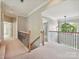 Upstairs hallway featuring wooden banisters with black iron spindles, and a modern chandelier over landing at 16319 Ashlyn Chase Ct, Charlotte, NC 28277