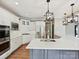 Kitchen with white cabinets, stainless steel appliances, subway tile backsplash, and island at 16319 Ashlyn Chase Ct, Charlotte, NC 28277