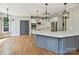Bright eat-in kitchen with island, white cabinets and stainless steel appliances at 16319 Ashlyn Chase Ct, Charlotte, NC 28277