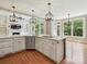 Eat-in kitchen boasting white cabinets, stainless appliances, island and backyard views at 16319 Ashlyn Chase Ct, Charlotte, NC 28277