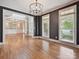 Open living room with hardwood floors, dark gray walls, and large windows with natural light at 16319 Ashlyn Chase Ct, Charlotte, NC 28277