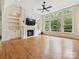 Bright living room with fireplace, built-in shelves, hardwood floors, and large windows at 16319 Ashlyn Chase Ct, Charlotte, NC 28277
