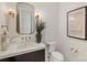 Stylish powder room featuring marble countertop and designer gold fixtures at 1719 Shoreham Dr, Charlotte, NC 28211