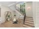 Bright entryway featuring a staircase, large windows, and stylish decor elements at 1719 Shoreham Dr, Charlotte, NC 28211