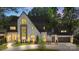 Beautiful brick home exterior with elegant design, illuminated by soft outdoor lighting at 1719 Shoreham Dr, Charlotte, NC 28211