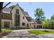 Stunning painted brick home showcasing a curved driveway and attached two car garage at 1719 Shoreham Dr, Charlotte, NC 28211