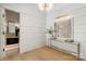 Bright foyer with wood floors leads to a view of a bathroom at 1719 Shoreham Dr, Charlotte, NC 28211