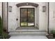 Elegant front door with a brick surround, and sconces on either side at 1719 Shoreham Dr, Charlotte, NC 28211