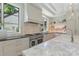 Well-appointed kitchen with stainless steel appliances, black countertops, and floating shelves at 1719 Shoreham Dr, Charlotte, NC 28211