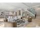 Bright living room features an open floor plan, modern furnishings, and a staircase with a black iron railing at 1719 Shoreham Dr, Charlotte, NC 28211