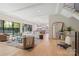 Open-concept living room featuring hardwood floors, neutral decor, and backyard access at 1719 Shoreham Dr, Charlotte, NC 28211
