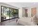 Bright main bedroom with dark hardwood floors and large glass doors overlooking the backyard at 1719 Shoreham Dr, Charlotte, NC 28211